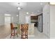 Open kitchen with stainless steel appliances and bar seating at 2124 Hames Ln, The Villages, FL 32162