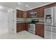 Charming kitchen featuring stainless appliances and granite countertops at 2124 Hames Ln, The Villages, FL 32162