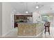 Bright kitchen with stainless appliances, dark wood cabinets and decorative stone backsplash at 2124 Hames Ln, The Villages, FL 32162