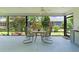 Screened lanai featuring table, chairs and views of the backyard at 2124 Hames Ln, The Villages, FL 32162