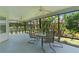 Screened lanai featuring table, chairs and views of the backyard at 2124 Hames Ln, The Villages, FL 32162