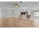 Spacious living room adjacent to the kitchen featuring hardwood floors and ceiling fan at 2124 Hames Ln, The Villages, FL 32162