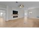 Open-concept living room featuring fireplace and view of the front entry and kitchen at 2124 Hames Ln, The Villages, FL 32162