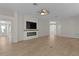Light and airy living room featuring wood floors and a modern electric fireplace beneath a flat screen television at 2124 Hames Ln, The Villages, FL 32162