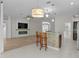 Open-concept kitchen with breakfast bar adjacent to the well-lit living room featuring an electric fireplace at 2124 Hames Ln, The Villages, FL 32162