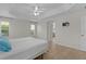 Bright main bedroom featuring a tray ceiling and hardwood floors at 2124 Hames Ln, The Villages, FL 32162