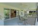 Screened porch offering outdoor dining and easy access to the kitchen through sliding glass doors at 2124 Hames Ln, The Villages, FL 32162