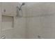 Nicely tiled shower with a handheld shower head and a decorative tiled stripe at 2124 Hames Ln, The Villages, FL 32162
