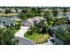 Aerial view of a single-Gathering home situated on a large lot with lush landscaping near a pond at 2237 Avon Loop, The Villages, FL 32162