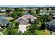 Aerial view of a single-Gathering home with a paver driveway, a two-car garage, and views of the pond at 2237 Avon Loop, The Villages, FL 32162