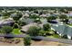 Aerial view of a well-kept backyard with mature trees and partial view of the community at 2237 Avon Loop, The Villages, FL 32162