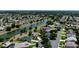 Aerial view of neighborhood featuring waterfront properties, mature trees, and well-maintained landscaping at 2237 Avon Loop, The Villages, FL 32162