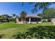 Large backyard with lush lawn and mature landscaping to enjoy outdoor living at 2237 Avon Loop, The Villages, FL 32162