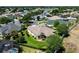 Aerial view of a backyard showcasing the home's well-kept lawn, mature trees, and screened-in pool area at 2237 Avon Loop, The Villages, FL 32162
