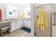 Bright bathroom with double vanity, granite countertop, and glass enclosed shower at 2237 Avon Loop, The Villages, FL 32162