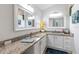 Bathroom featuring double sinks, vanity with granite counter top, and matching mirrors at 2237 Avon Loop, The Villages, FL 32162