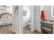 En suite bathroom has granite counters, wood-look flooring, and a connecting bedroom at 2237 Avon Loop, The Villages, FL 32162
