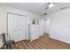 Bright bedroom features wood flooring, neutral walls, and closet for ample storage space at 2237 Avon Loop, The Villages, FL 32162