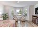 Cozy bedroom with luxury vinyl plank flooring, ceiling fan, and bay window sitting area at 2237 Avon Loop, The Villages, FL 32162