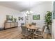 Bright dining area with a round table, art and cabinet for display, and lots of natural light at 2237 Avon Loop, The Villages, FL 32162