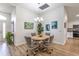 Inviting dining room with stylish lighting and artwork, adjacent to the kitchen at 2237 Avon Loop, The Villages, FL 32162