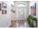 Bright entryway featuring a decorative front door, sidelights, and wood-look flooring at 2237 Avon Loop, The Villages, FL 32162