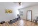Bright exercise room featuring luxury vinyl plank flooring and ceiling fan and wall art at 2237 Avon Loop, The Villages, FL 32162