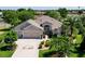 Charming single Gathering home with a two car garage, paver driveway, and manicured landscaping at 2237 Avon Loop, The Villages, FL 32162