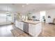Bright, open kitchen features a large island with granite countertops and stainless steel appliances at 2237 Avon Loop, The Villages, FL 32162
