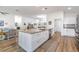 Spacious kitchen featuring stainless steel appliances, hardwood floors, and a large center island at 2237 Avon Loop, The Villages, FL 32162