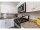 Well-equipped kitchen featuring white cabinets, stainless steel appliances, and granite countertops at 2237 Avon Loop, The Villages, FL 32162
