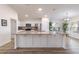 Open concept kitchen with white cabinets, granite countertops, a stainless steel refrigerator and a kitchen island at 2237 Avon Loop, The Villages, FL 32162