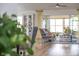 Bright living room featuring hardwood floors, a decorative cabinet, and sliding glass doors to the lanai at 2237 Avon Loop, The Villages, FL 32162