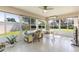 Bright sunroom with tile floors, ceiling fan, lots of windows and views of the green lawn at 2237 Avon Loop, The Villages, FL 32162