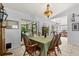 Cozy dining area with a unique light fixture, a table set for six, and sliding door access to outdoors at 227 Oak Rd, Winter Springs, FL 32708