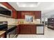 Updated kitchen with stainless steel appliances, granite countertops, and cherry wood cabinets at 227 Oak Rd, Winter Springs, FL 32708
