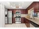 Updated kitchen with stainless steel appliances, granite countertops, and cherry wood cabinets at 227 Oak Rd, Winter Springs, FL 32708