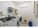 Laundry room with a washer, dryer, shelving and a pet door at 227 Oak Rd, Winter Springs, FL 32708