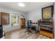 A home office with warm wood flooring, shelves, and a view of the yard at 227 Oak Rd, Winter Springs, FL 32708