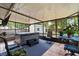 An enclosed patio with a hot tub, tile accents and a view of the backyard at 227 Oak Rd, Winter Springs, FL 32708