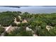 Aerial view of the property showcasing its location near the water, and the tree coverage at 26 Weston Rd, Leesburg, FL 34748
