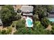 A lovely home has a backyard with a pool and mature landscaping at 26 Weston Rd, Leesburg, FL 34748