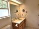 Bathroom featuring a mirror, sink, vanity, and window with natural light at 26 Weston Rd, Leesburg, FL 34748