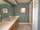 Bathroom with double sinks, framed mirrors, and a neutral color palette at 26 Weston Rd, Leesburg, FL 34748