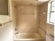Bathroom featuring a bathtub, shower, window with natural light, and tile at 26 Weston Rd, Leesburg, FL 34748