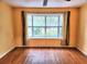 Bright bedroom with hardwood floors, neutral walls, and a large bay window at 26 Weston Rd, Leesburg, FL 34748