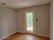 Bedroom featuring laminate flooring and a sliding glass door to a deck at 26 Weston Rd, Leesburg, FL 34748