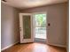 Bedroom featuring laminate flooring and a sliding glass door to a deck at 26 Weston Rd, Leesburg, FL 34748