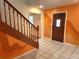 Entryway boasts tile floors, colorful wall design, and a wood door with glass panel at 26 Weston Rd, Leesburg, FL 34748