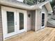Exterior shot of the home, with double doors leading to a wooden deck at 26 Weston Rd, Leesburg, FL 34748